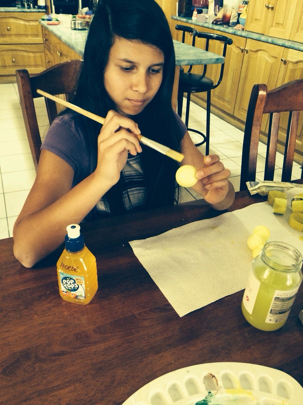 Paint the styrofoam balls yellow.