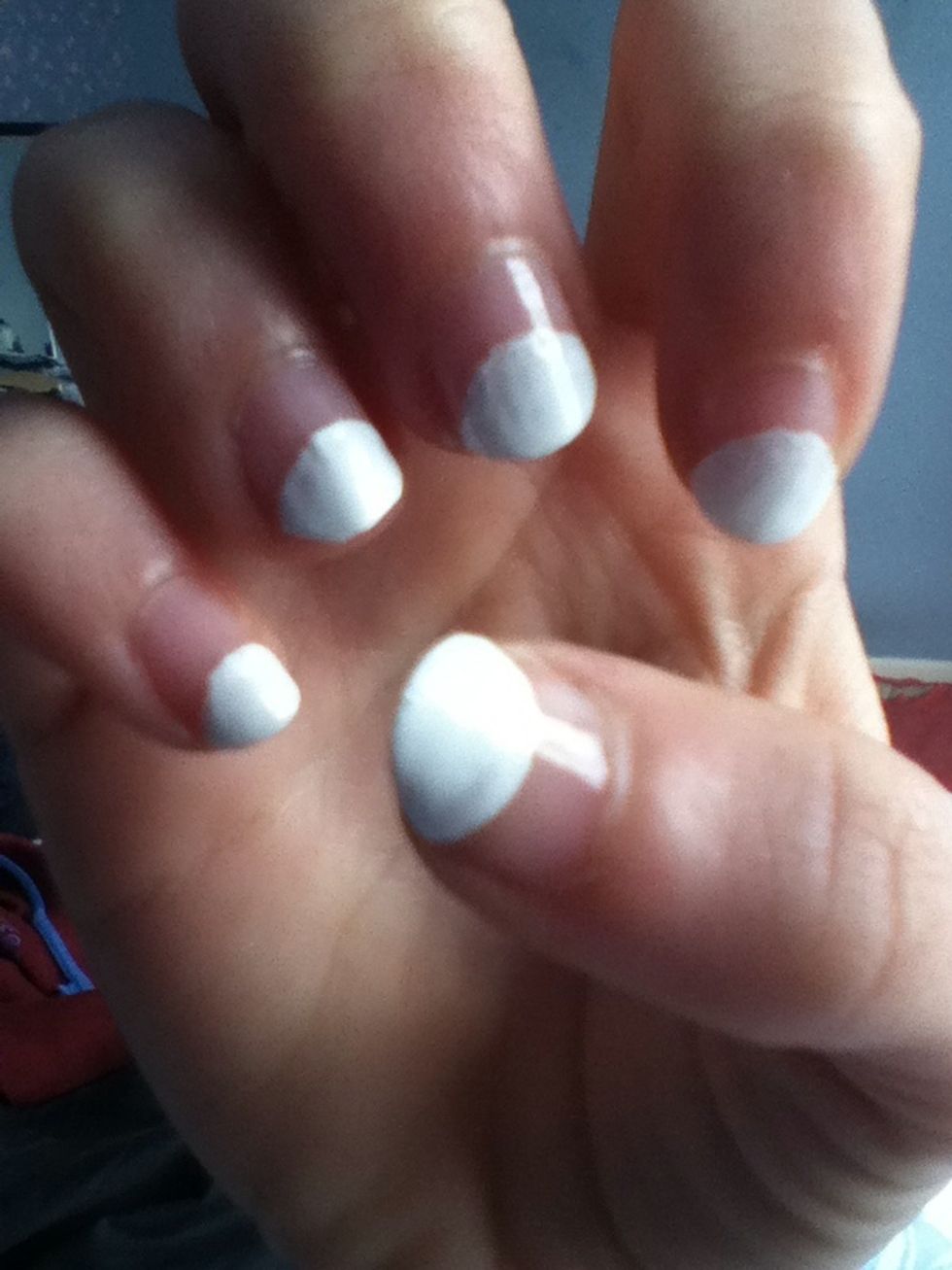 Paint the tip of you nail white and then continue along the nail to create a curve. This will make the body.