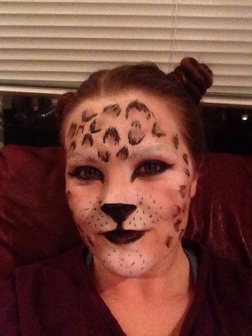 Paint the tip of your nose and mouth black, and some dots to resemble whiskers