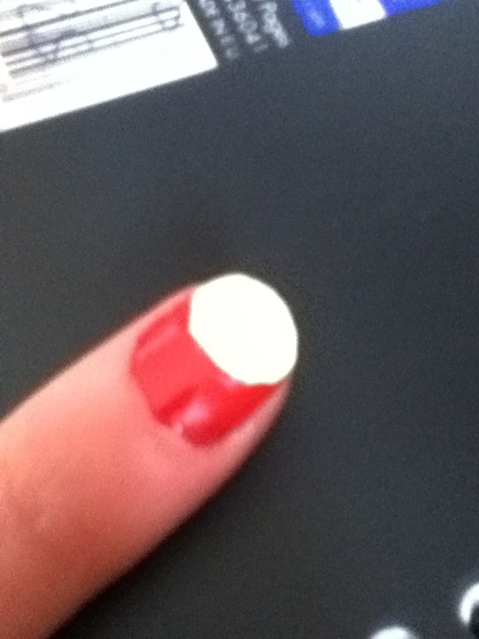Paint the top half of nail white, with the bottom slightly curved.