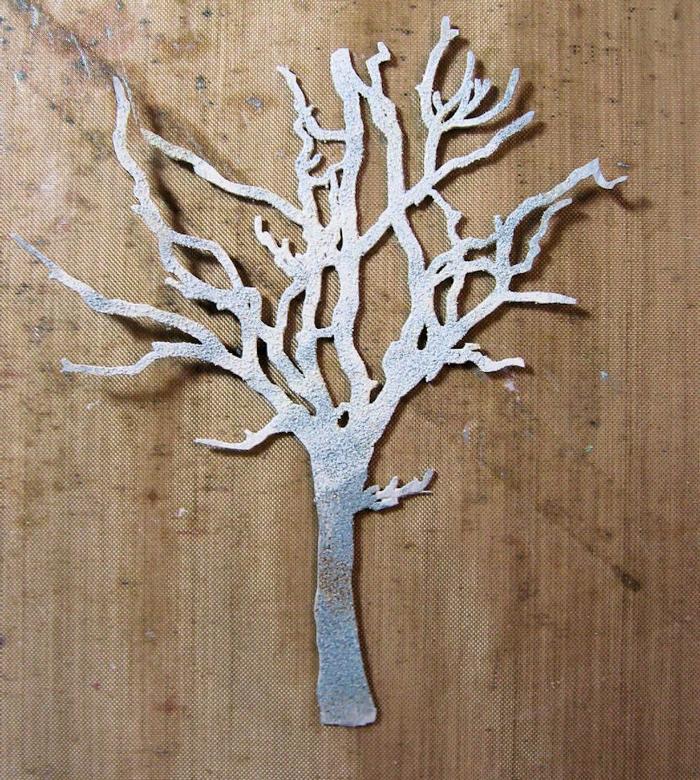 Paint the tree trunk with Iced Spruce Distress paint.  While paint is still wet, sprinkle with embossing powders.  Heat emboss.