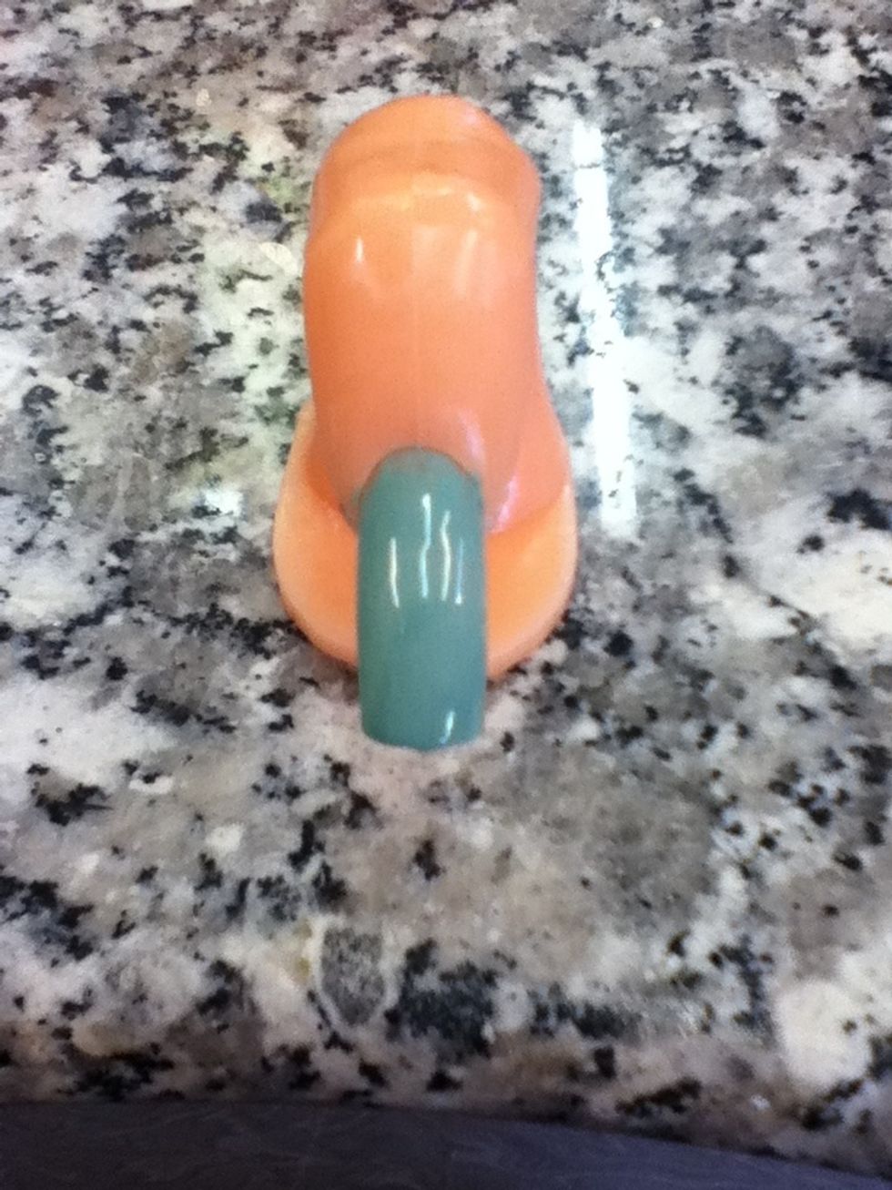 Paint the whole nail with a light bluish greenish nail polish.