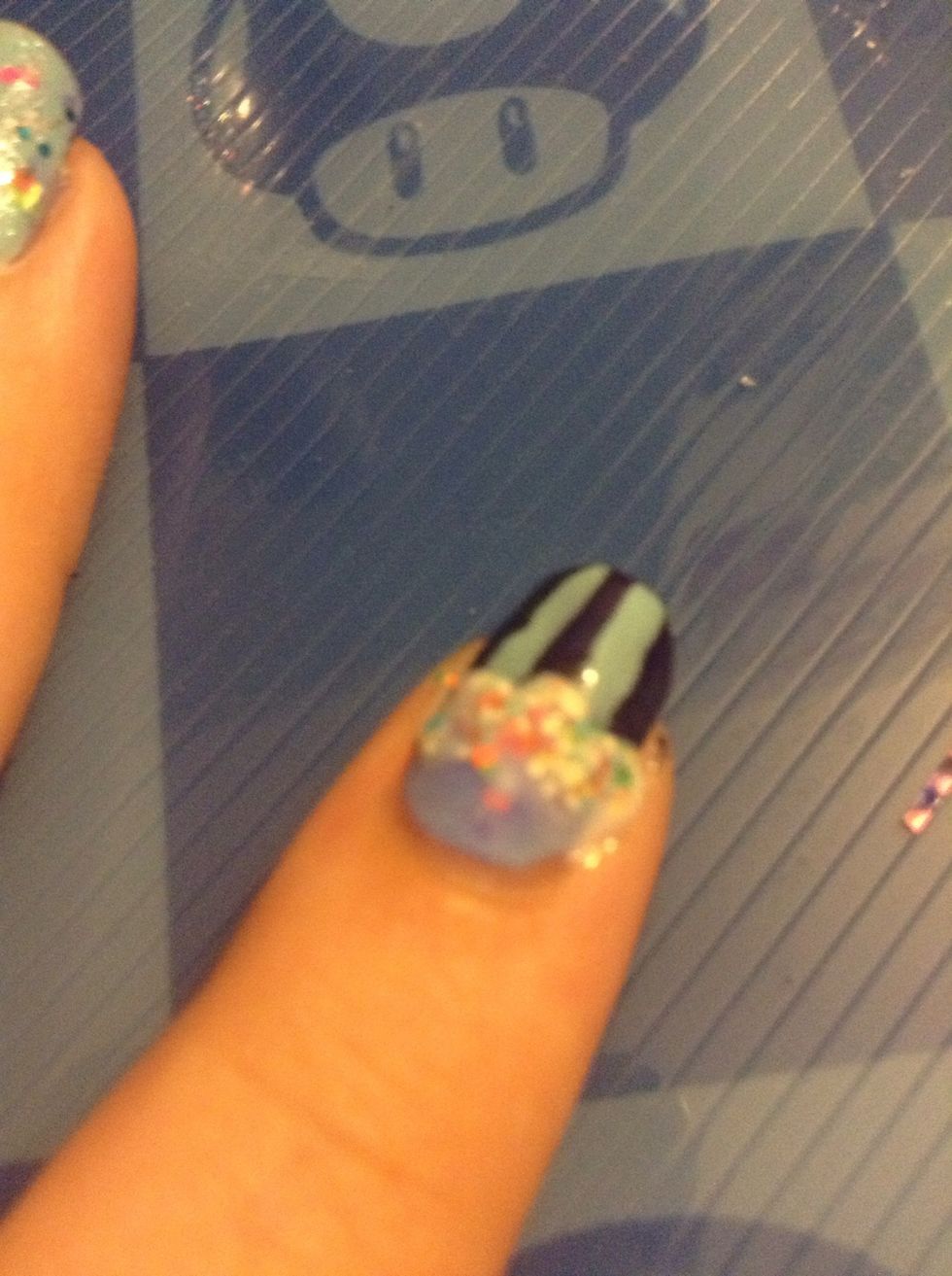 Paint three big dots with whatever color you want the top part to be. Make sure they're covering just the start of the cup part. I'm using It's A Trap-eze from China Glaze.