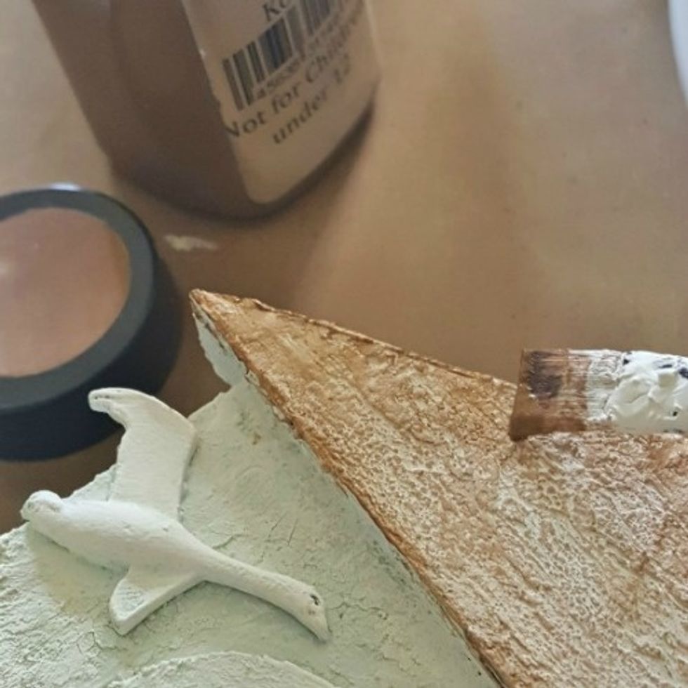 Paint top portion of lighthouse with Velvet medium - Kona and spray overtop with Colorations spray - Warm