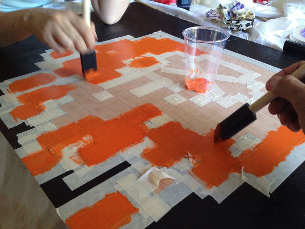 Paint using a regular brush or a sponge brush, as shown here. For lighter colors apply 2-3 coats. Make sure the paint is completely dry before peeling the tape, or it WILL bleed through.