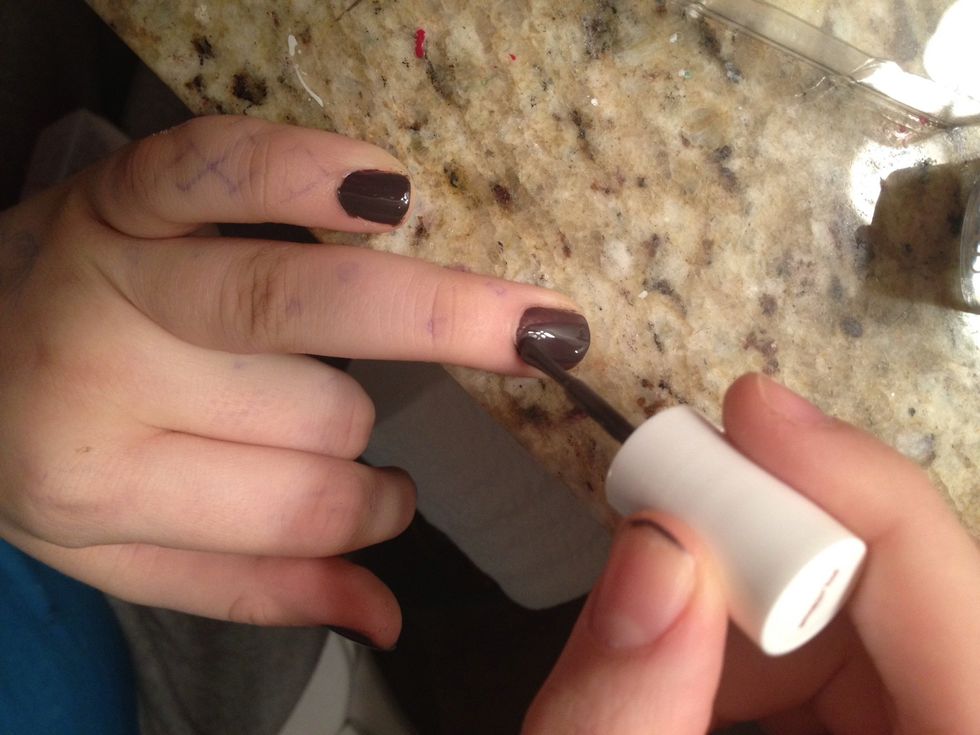 Paint your accent nail a second coat.