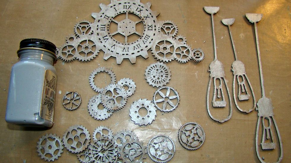 Paint your chipboard pieces with a coat of Metal Effects Silver. I used a stipple brush to provide a bit more texture instead of painting it on.