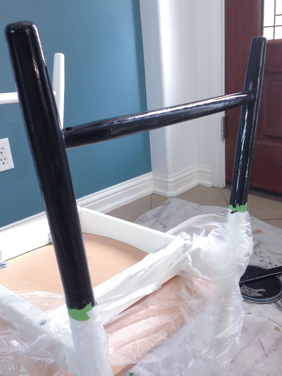 Paint your first coat of paint on the chair legs. When painting a smooth surface with a brush, you want to make sure that you don't over brush the paint. Good quality paint is self-leveling.