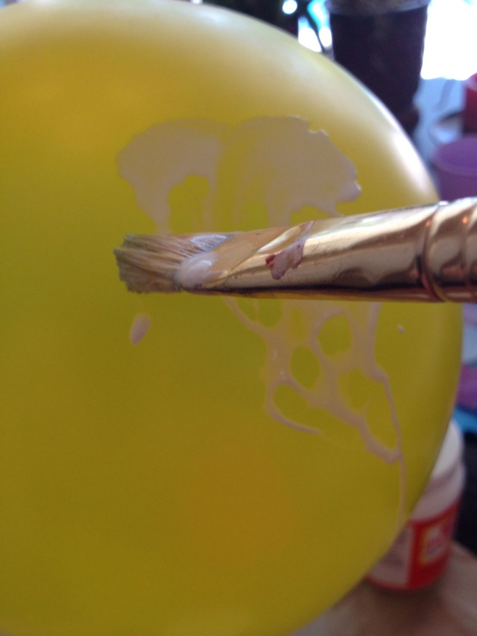 Paint your mixture on a small part of the top of the balloon.