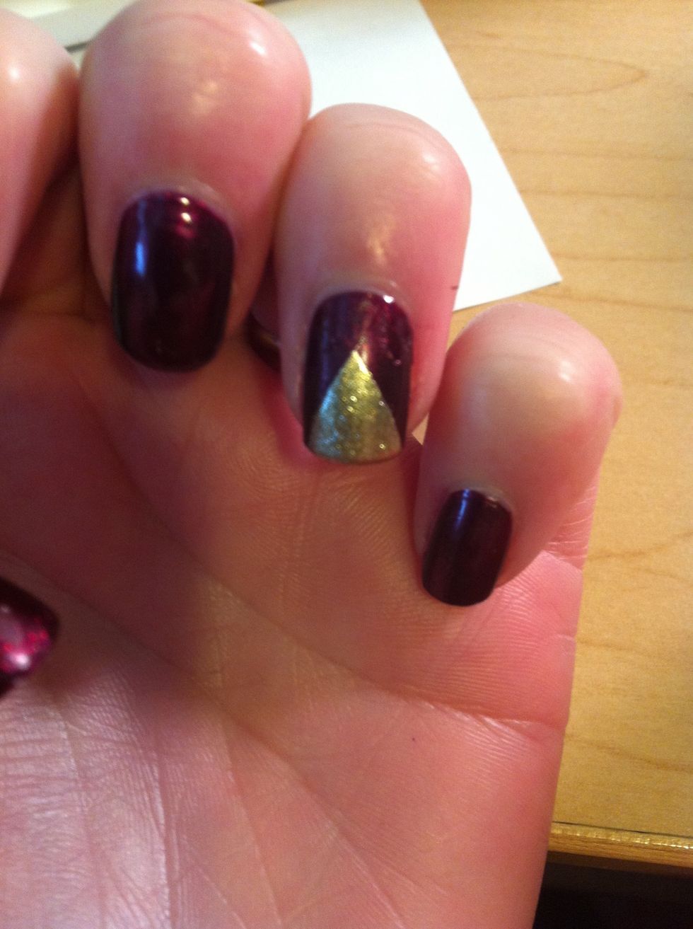Paint your nail with your accent color and remove the tape immediately. This will give your shape crisp edges. If you wait for it to dry you may pull up the polish.