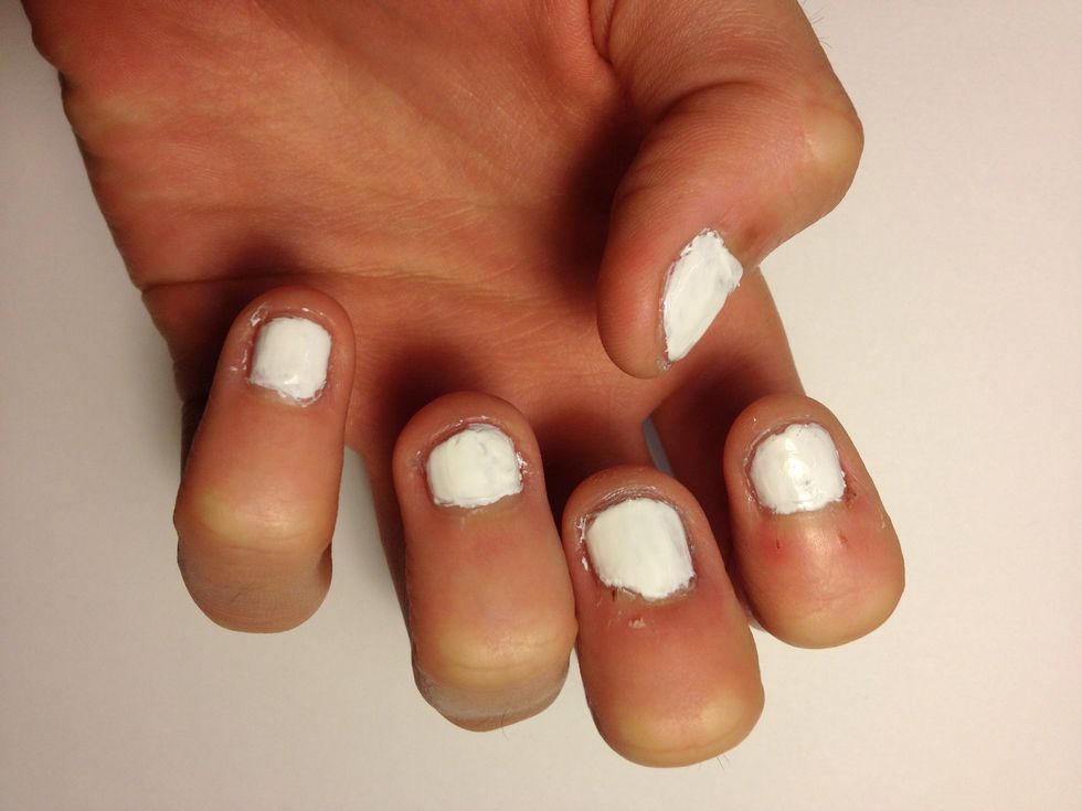 Paint your nails an even coat of white.