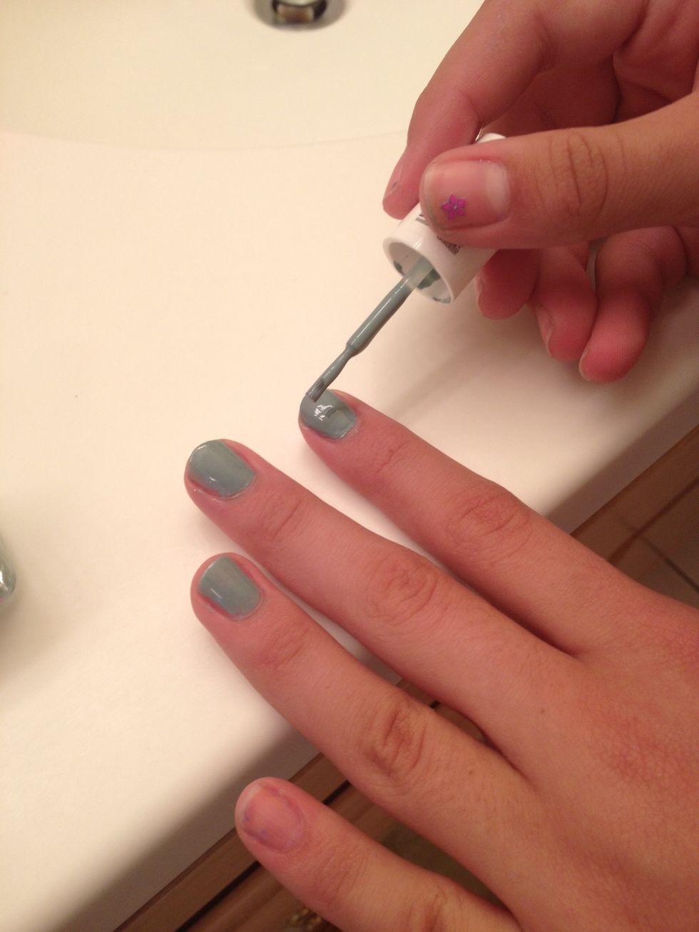 Paint your nails the light/base color.