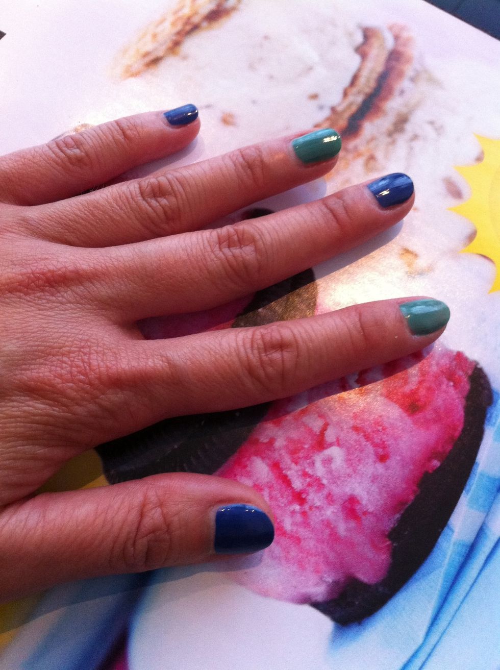 Paint your nails with the blue and green nail polish.