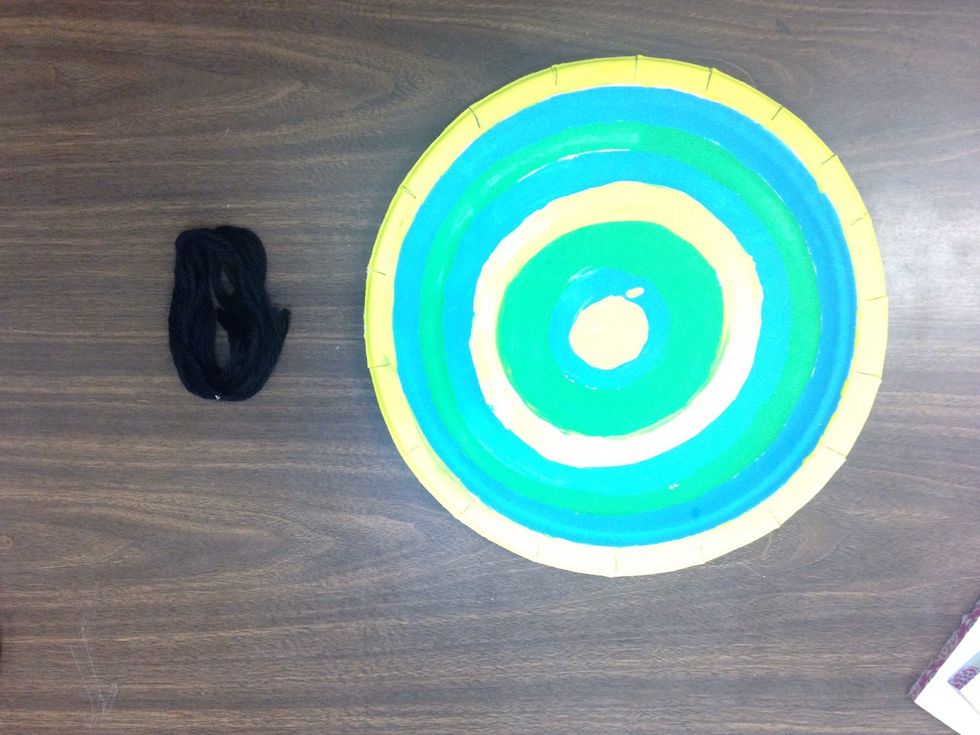 Paint your plate with concentric circles. Use the template to mark where to cut tabs. Grab some yarn!