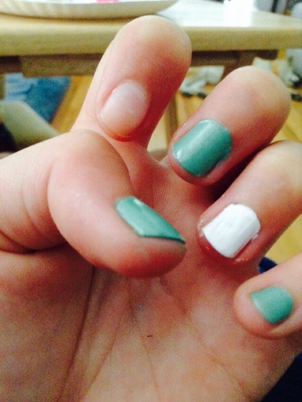 Paint your ring finger with 2 coats of white polish