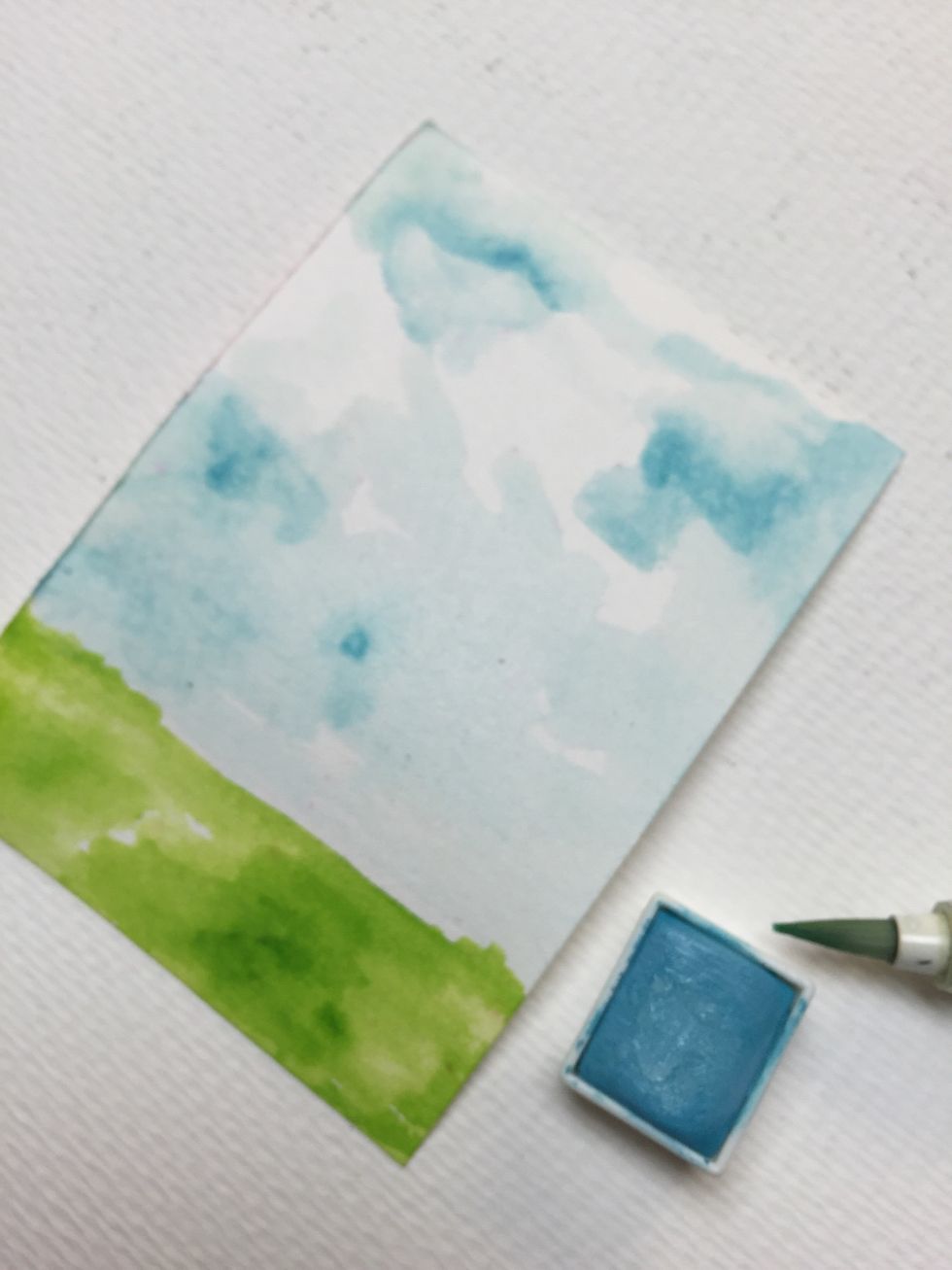 Paint your sky, remember to leave some random white spaces to represent clouds