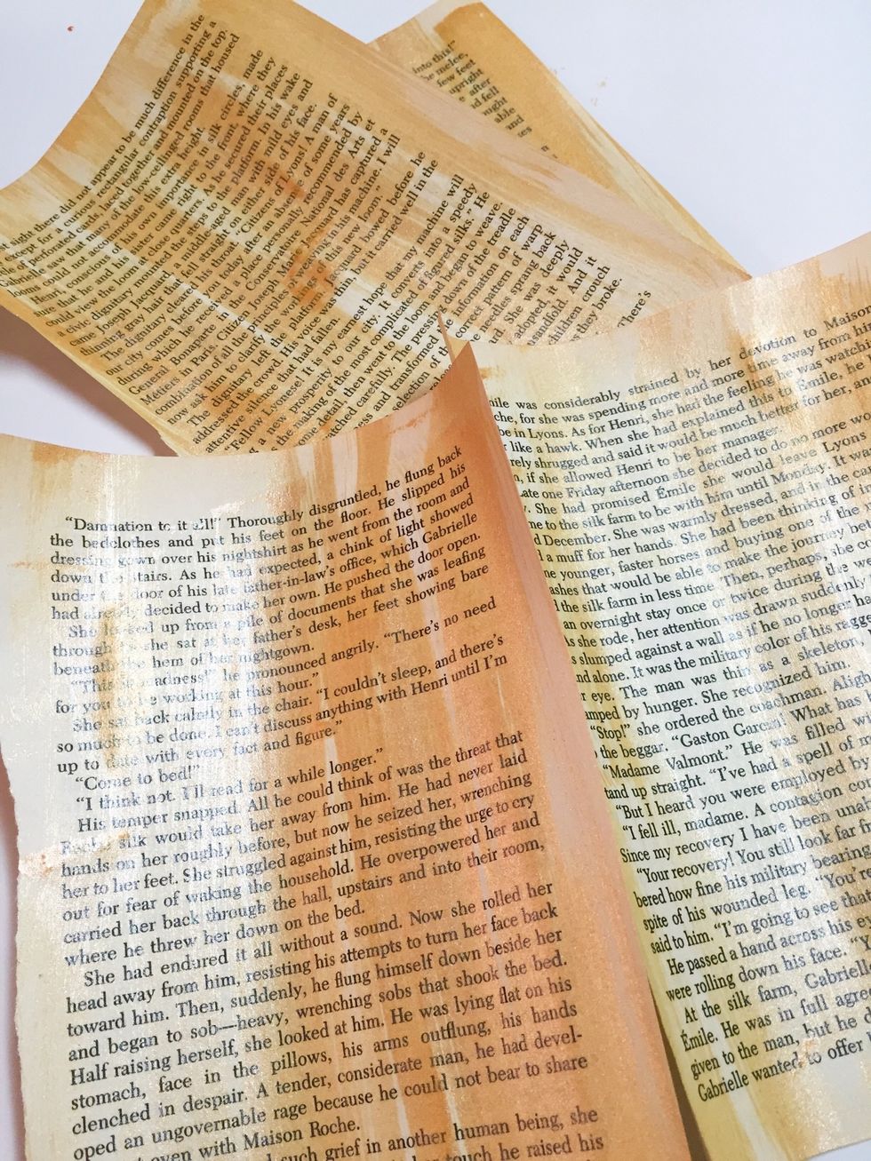 painted pages. the thin book pages may curl, just reroll the other way to flatten. pages don't need to be perfectly flat - they will smooth when adhesive is added to back.