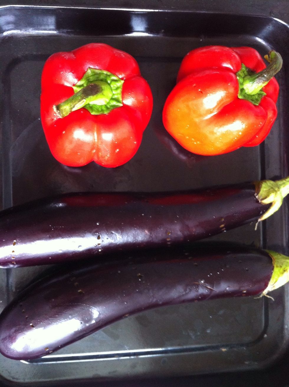Pappers and eggplants pierce with a fork and rub them with olive oil.