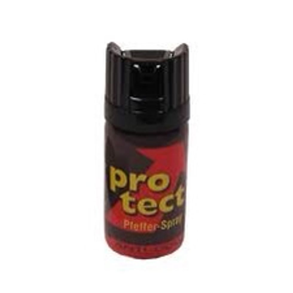 Paralyzing sprays are useless against dogs. But pepper  sprays will make the dog stop the fight or even die. You are able to buy those sprays in any hunting shops and their cost is low.