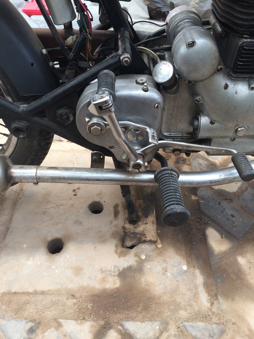 Park the motorcycle on a raised platform like a wooden plank or stone slab.