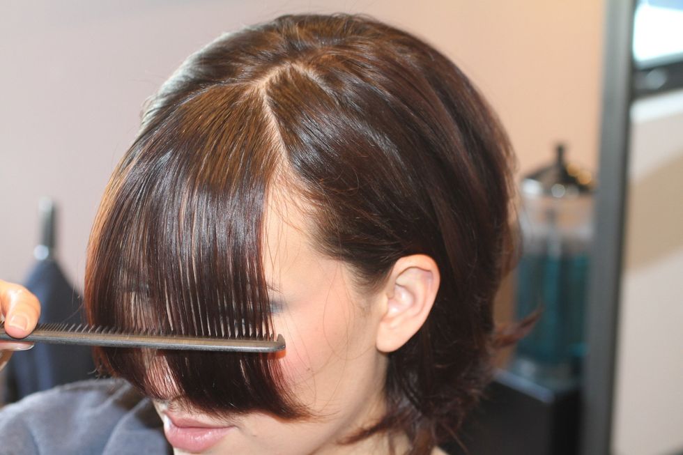 Part hair. Bangs begin where the top of the head starts to slope down toward the forehead. Comb hair down; grab the hair that falls between the outside edges of both eyebrows.