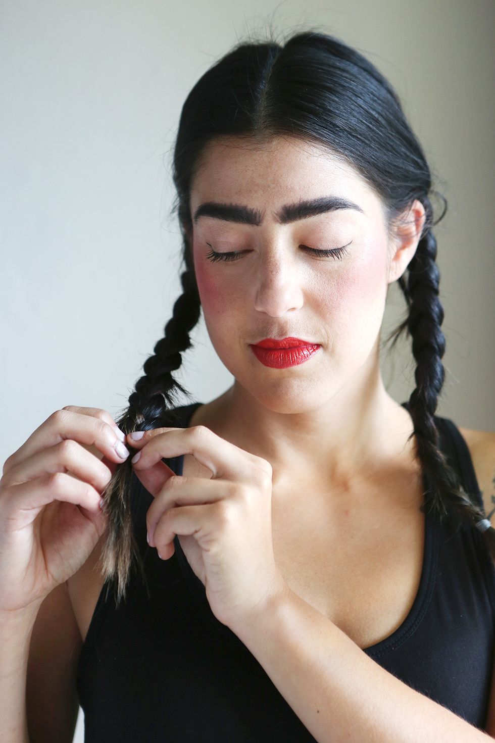 Part your hair down the middle and make two braids just behind your ears.