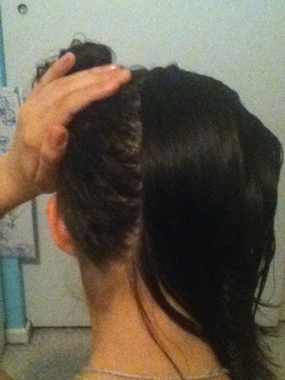 Part your hair straight down the middle. Tie one side up and to the side so it stays out of the way. Then comb it all back, so none is in your face or hanging down on the side.