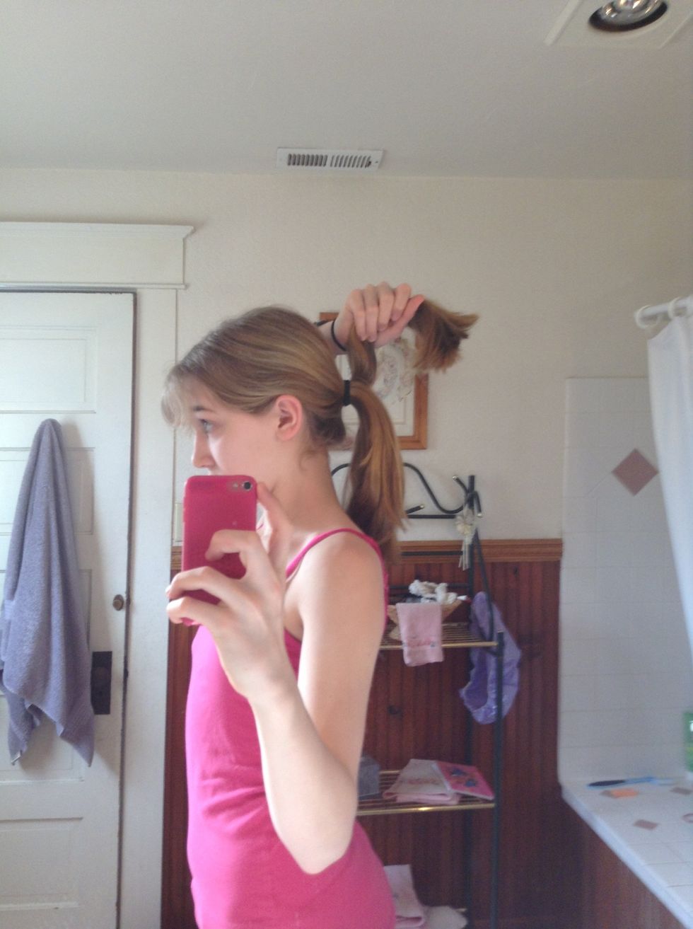 Part your ponytail into two pieces, and take one in each hand.