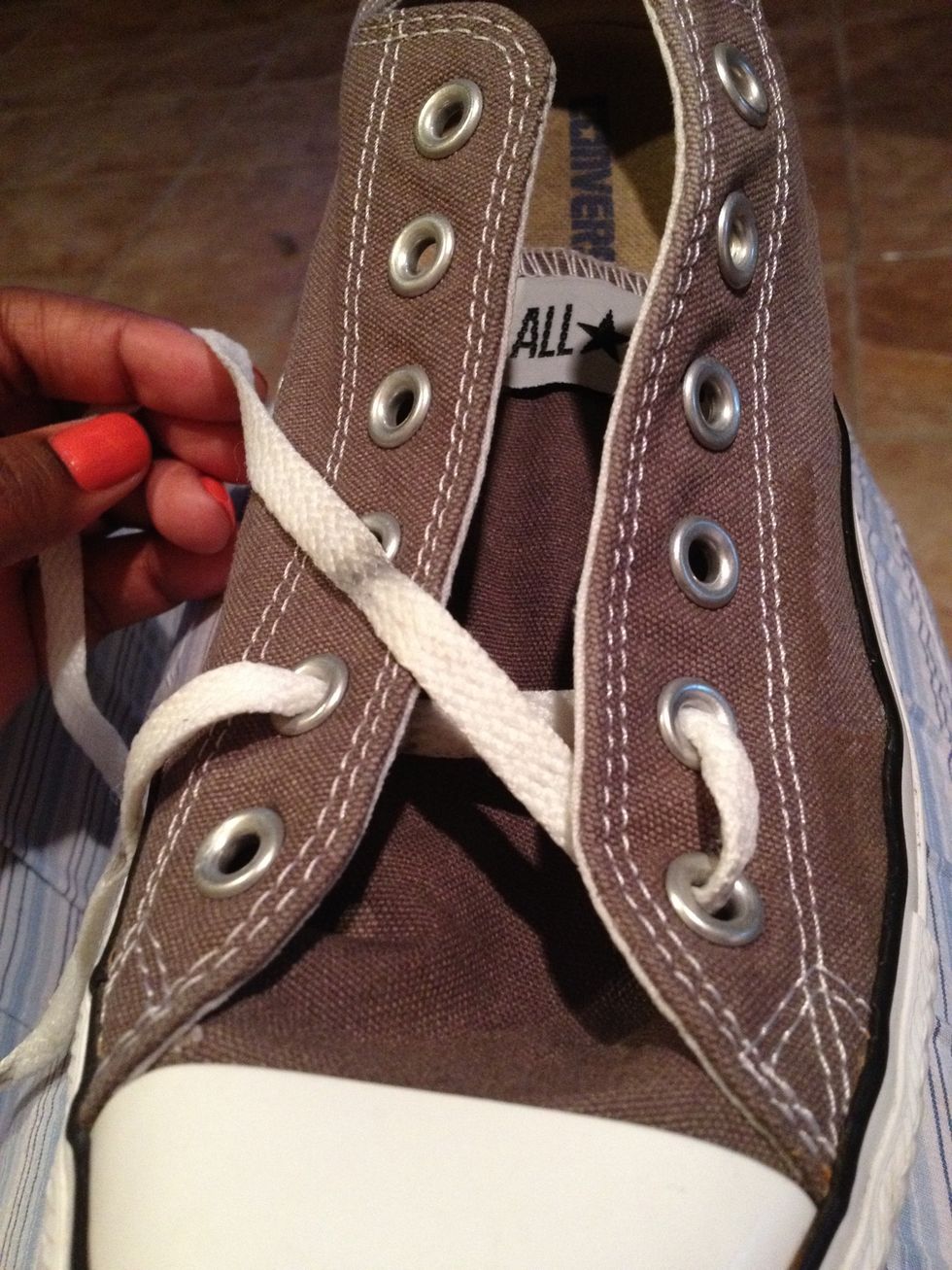 Pass one end of the lace down through the first eyelet (not crossing), over to under.