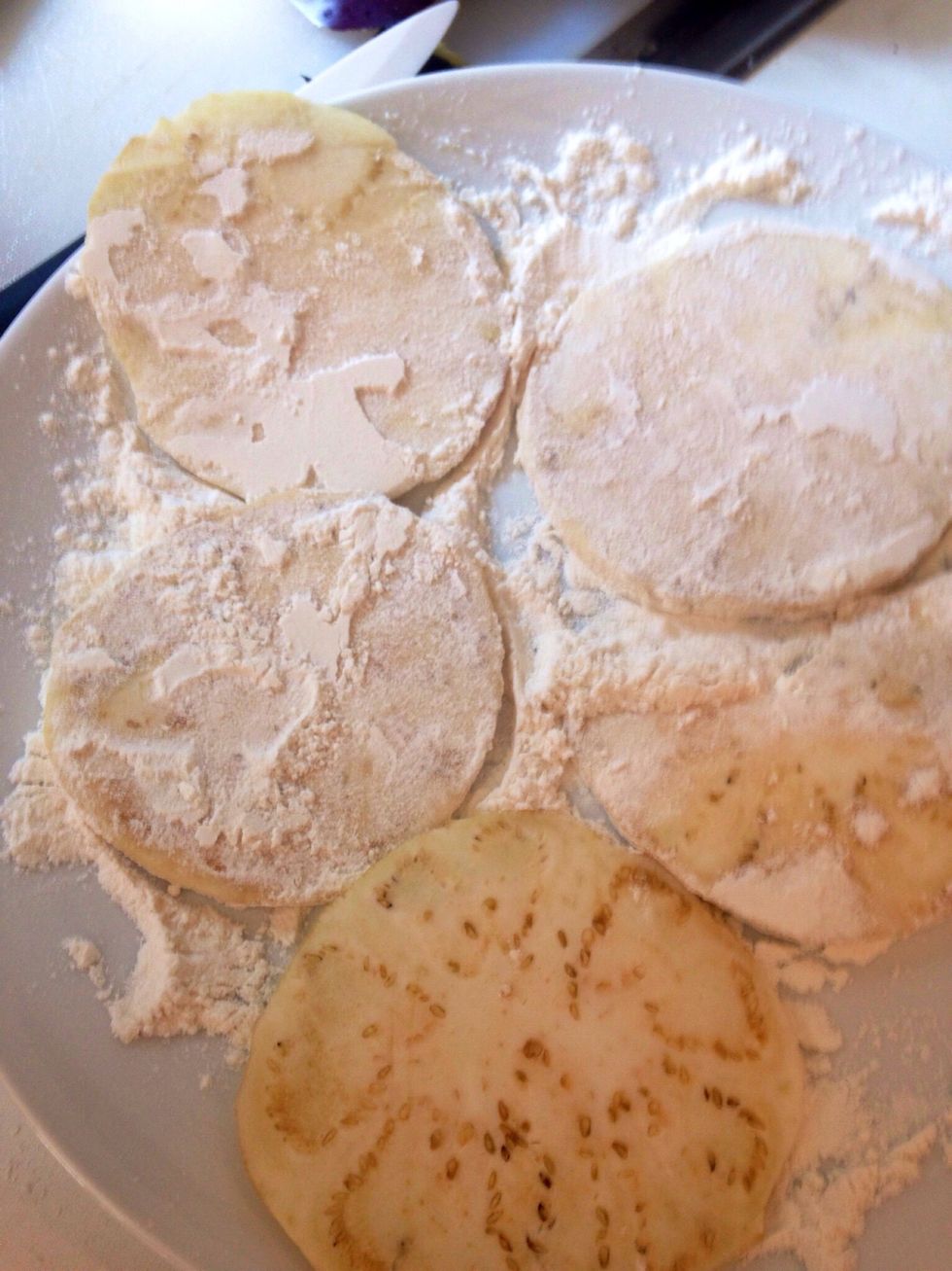Pass the aubergine slices into flour, then into a beaten egg and fry them in abundant oil