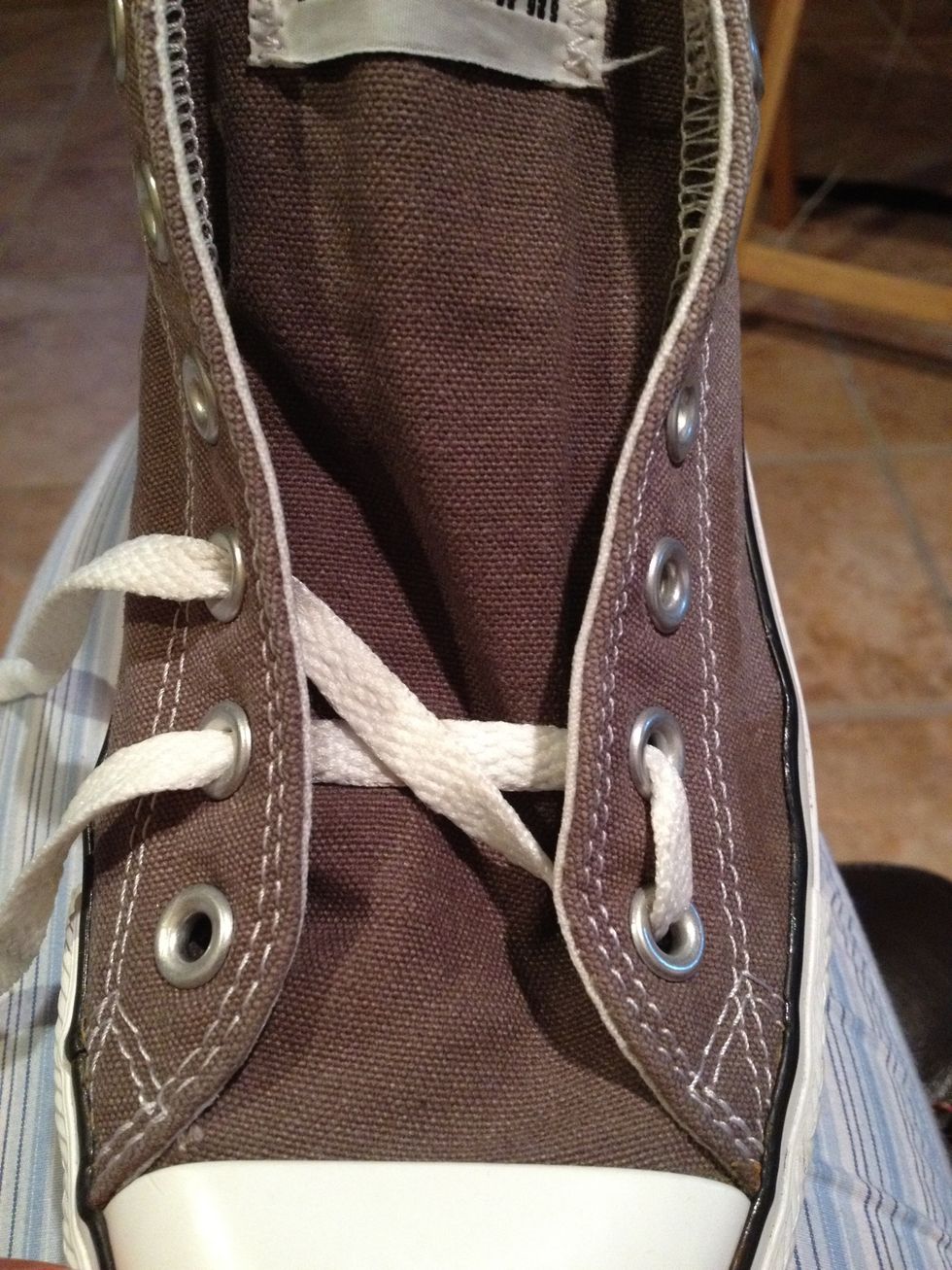 Pass the same lace across and up through eyelet three, under to over.