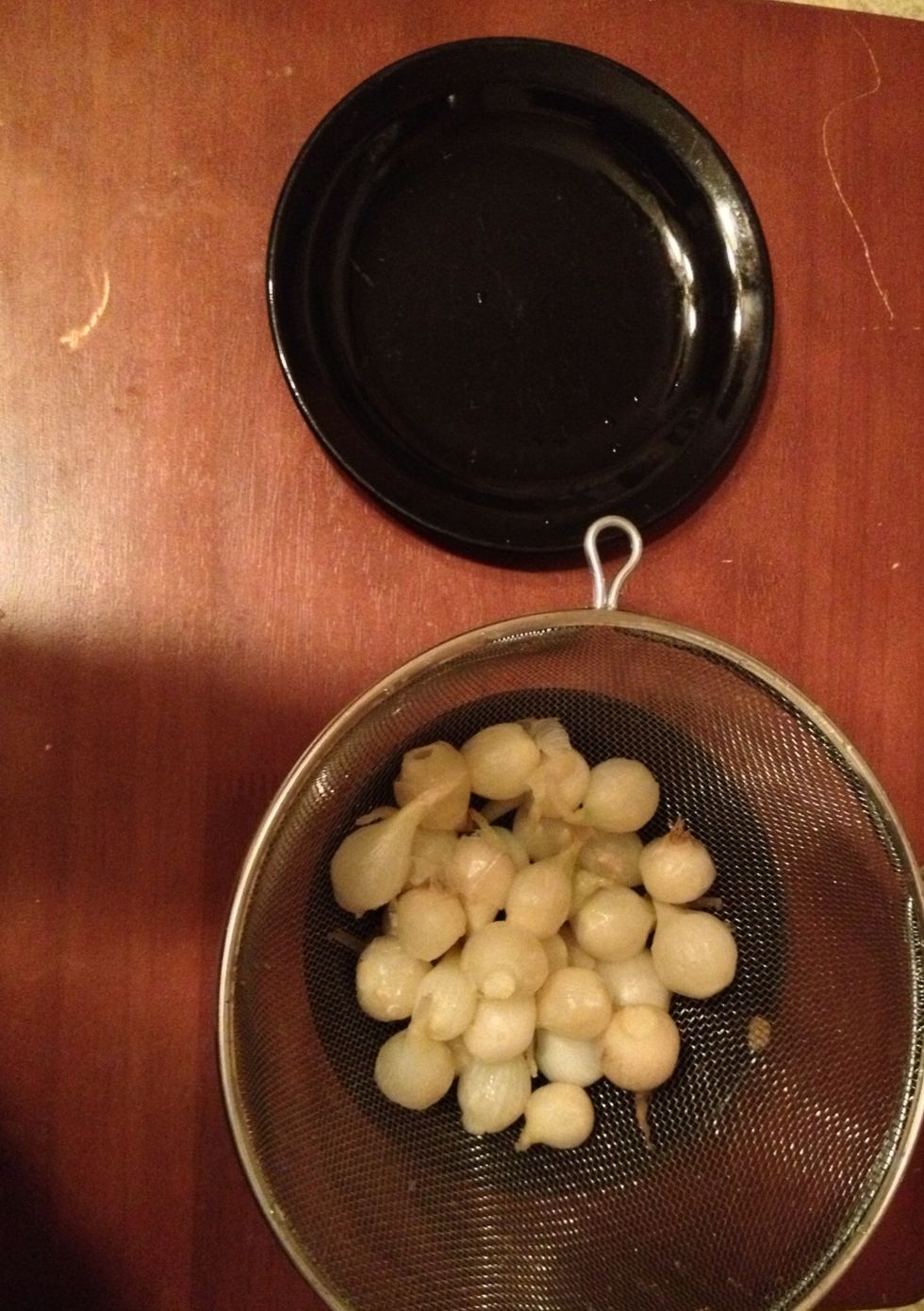 Pass through a strainer again, then place strainer in a bowl. Now we are ready to peel.