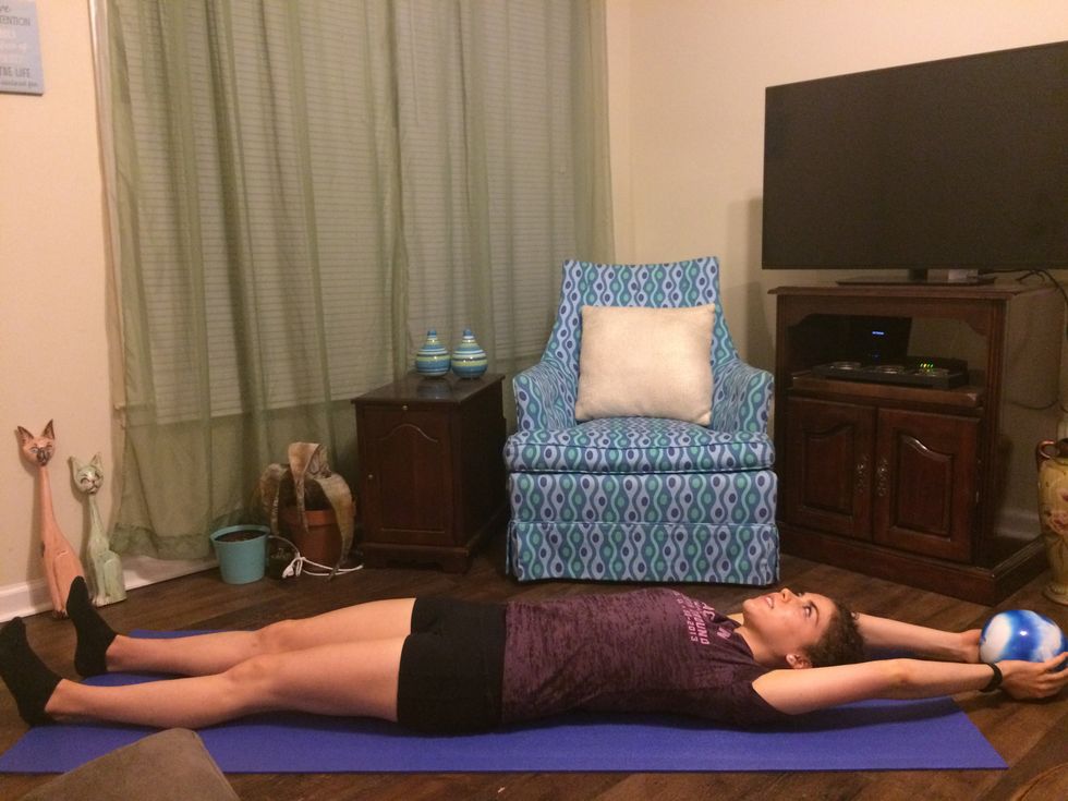 Passing Ball: Lay flat on your back with your arms extended above your head and the ball between your hands.