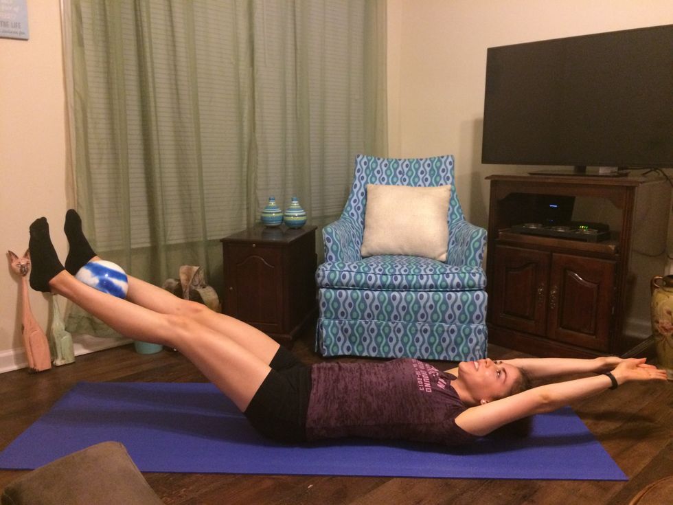 Passing Ball: Slowly lower your arms and legs down.