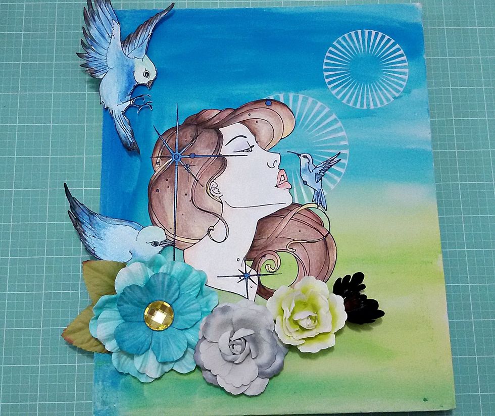 Paste stamped images in the canvas and some flowers.