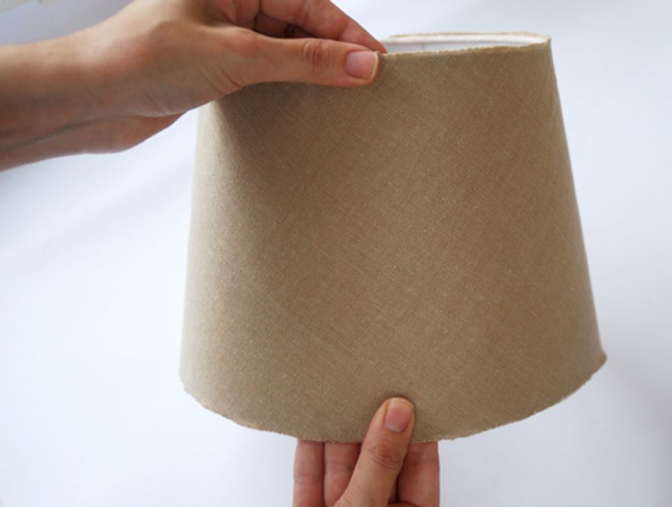Paste the fabric on the lampshade. It is important to attach the fabric smoothly to avoid creating bubbles and wrinkles.