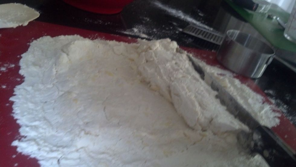 Pat the rectangle and use the knife to help lift one side of the rectangle to fold it into the middle of the rectangle. Think of a trifold of paper. Do the same to the other side. This is kneading it.