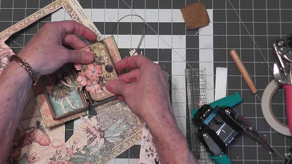 Pattern the pages with papers from the collection. Fussy cut different elements to decorate the outside of your box, the inside and each page.  Add assorted flowers, ribbons, trim, buttons & charms.