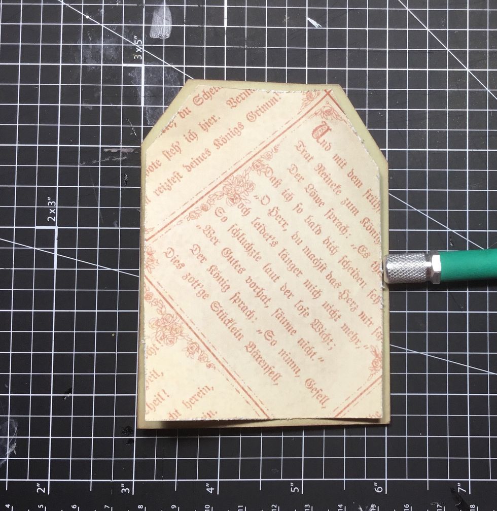 Patterned paper attached to front of folded tag.