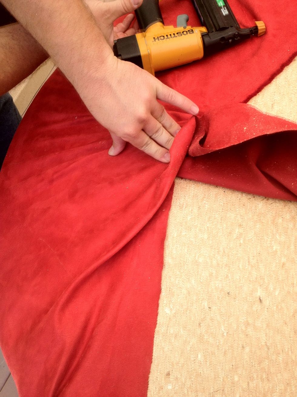 Pay attention to detail around the edges. Take time to make sure the cloth doesn't bunch or gather around to the top of the surface. Be patient. I often have to tear out staples and start over.