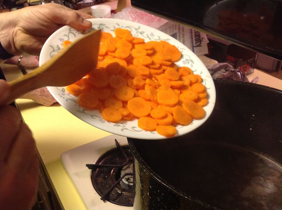 Peal and slice carrots, add to pot