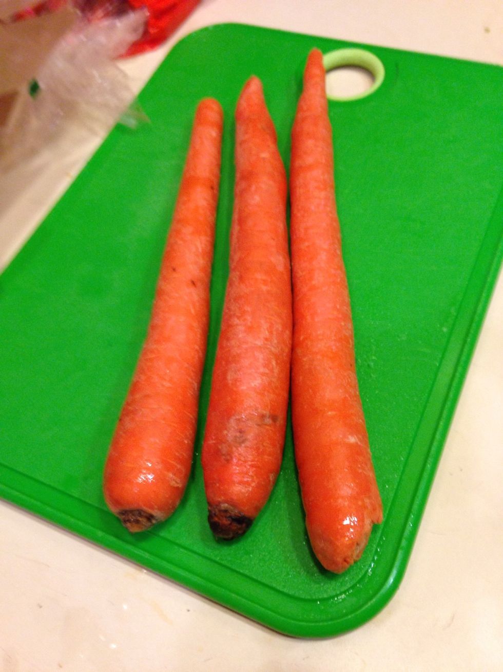 Peal of the skin. Cut the ends off the carrots and cut in half and place in the stock pot.