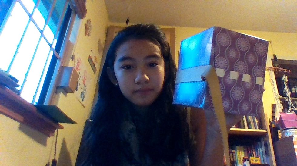 Peal off the plastic tab covers, and slowly work your way around the box: wrapping the ribbon around it (after you peal the covers off)