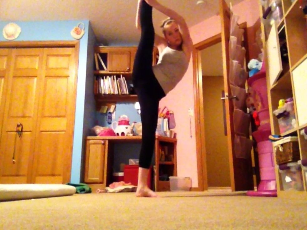 Peekaboo: start standing then grab your ankle with both hands and extend it straight up by your face. Make a hole between your arms like shown above for your head! Peekaboo! (: