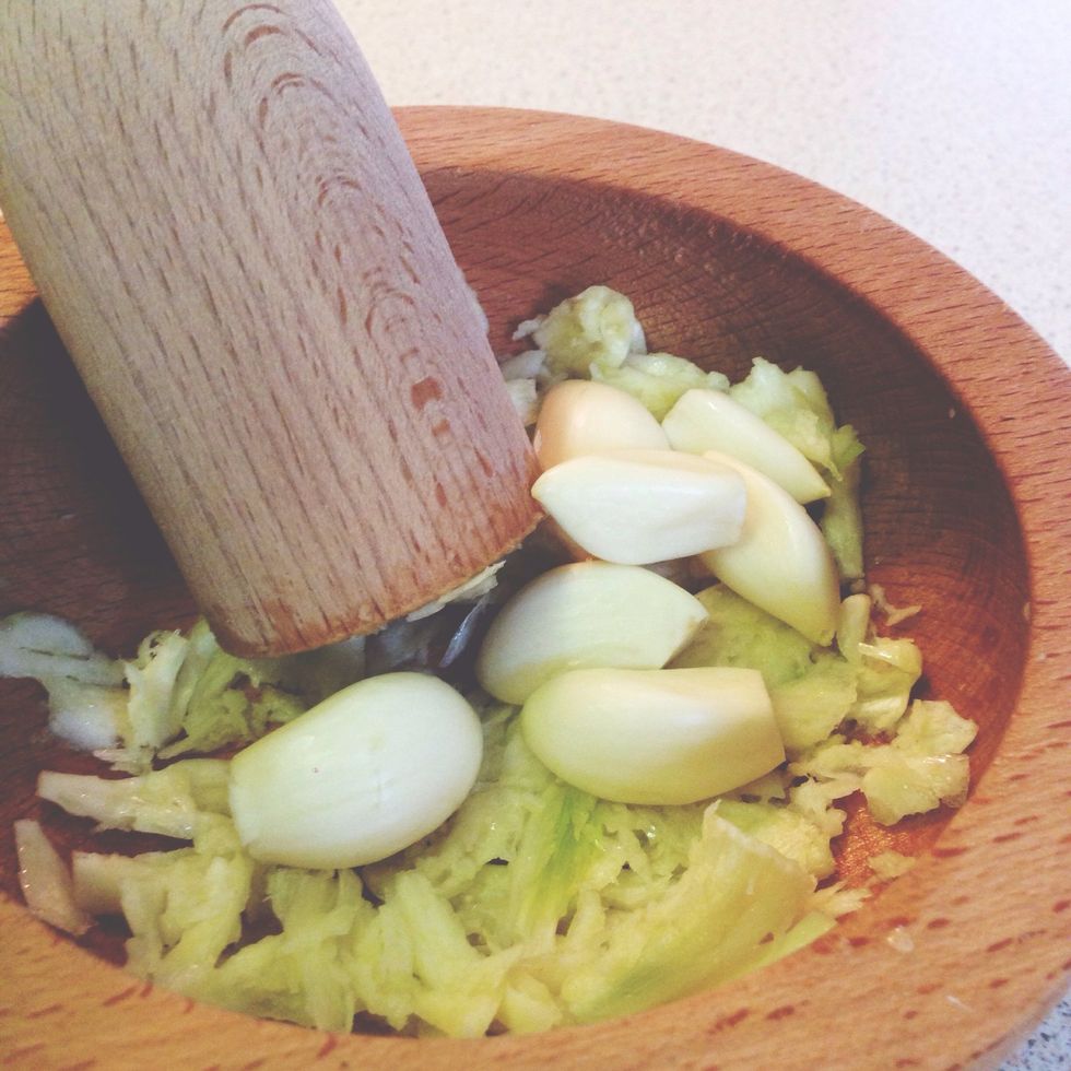 Peel 1 head of garlic (yes, 1 head!), and pound it in a pestle and mortar.