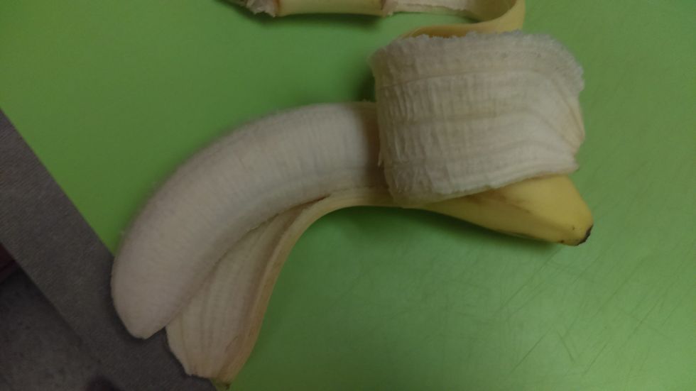 Peel a banana partially, leaving the unpeeled part for the octopus head.