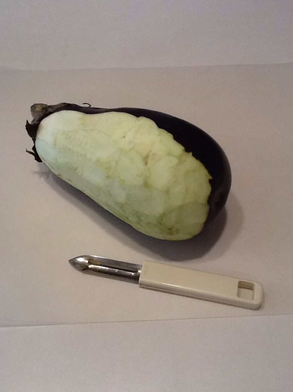 Peel an eggplant and slice into 1/2 inch round slices.