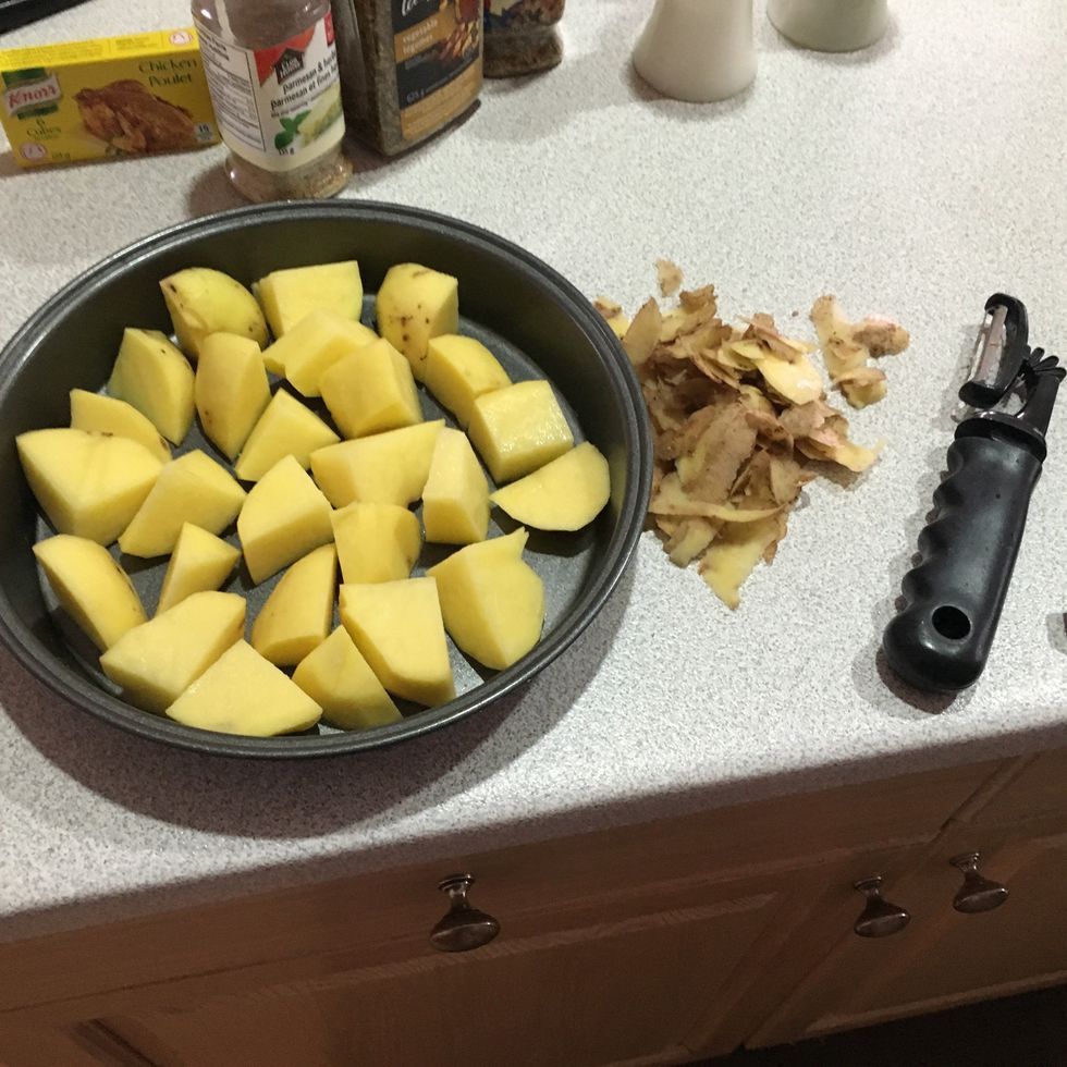 Peel and chop the potatoes and spread them evenly  in a small to medium sized baking pan.