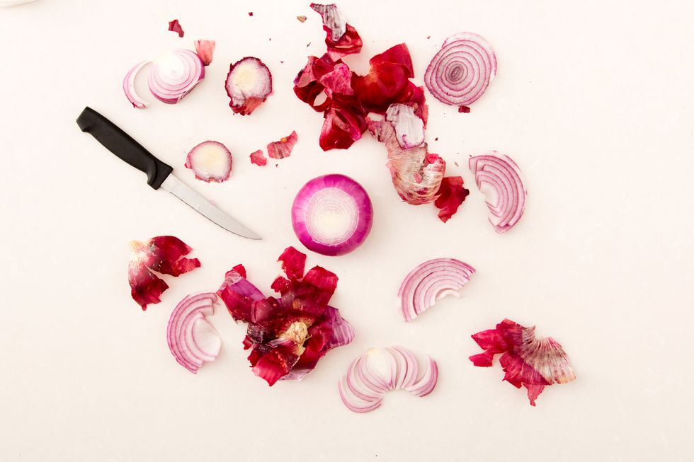 Peel and chop two small red onions.