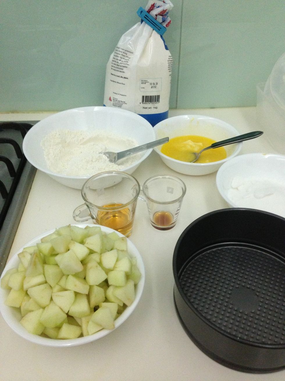 Peel and core the apples then dice into pieces. Butter the pan. Preheat oven to about 180c
